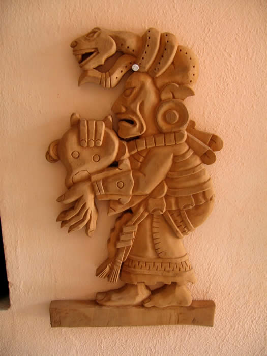 Carved wood reproduction by Miguel Uc Delgado of Ixchel, the Maya goddess of childbirth and weaving as she was depicted in one of the pages from the Postclassic Maya manuscript, the Dresden codex